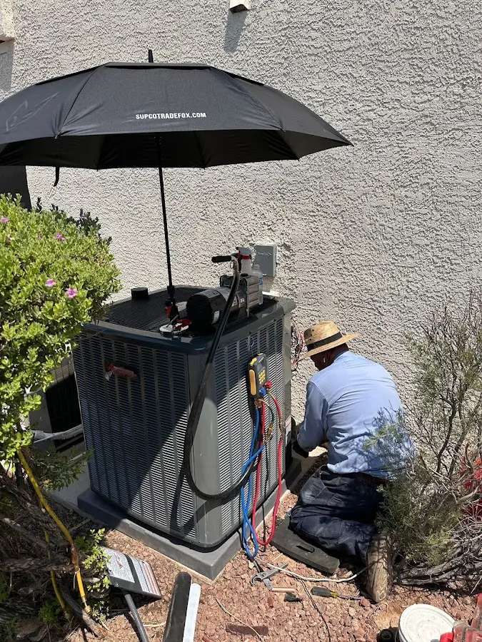 HVAC technician performing outdoor AC maintenance in Worcester
